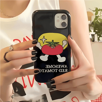 Person holding a phone with a cartoon tomato design on a black case.