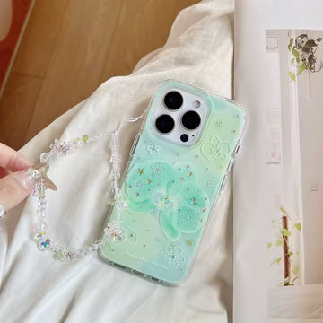 Phone case with decorative chain held by a hand on a light fabric background
