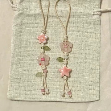 Decorative bookmarks with floral designs on a textured fabric background