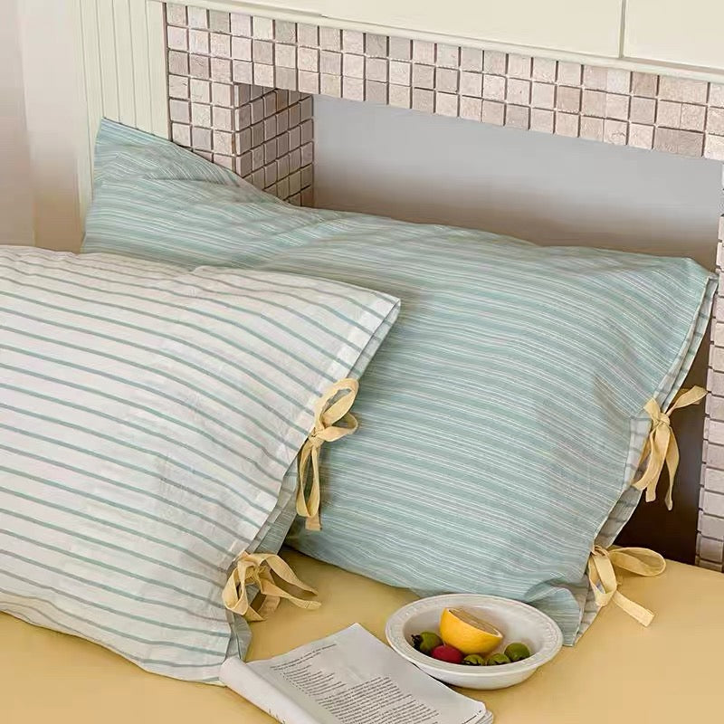 Nordic pastel striped pillow cover in lilac and grey, soft cotton fabric.