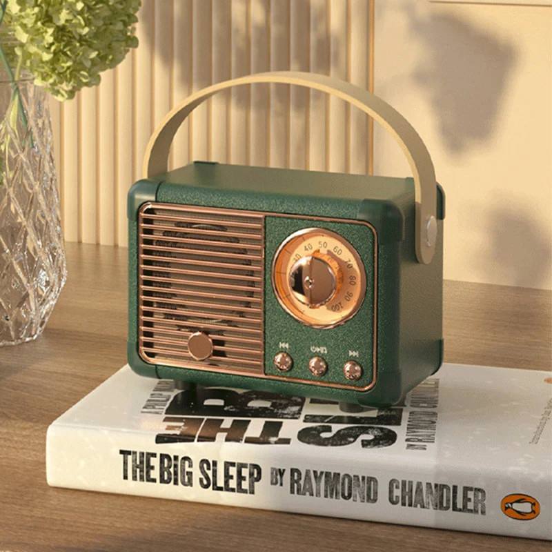 Vintage-style green radio on a book with a blurred background