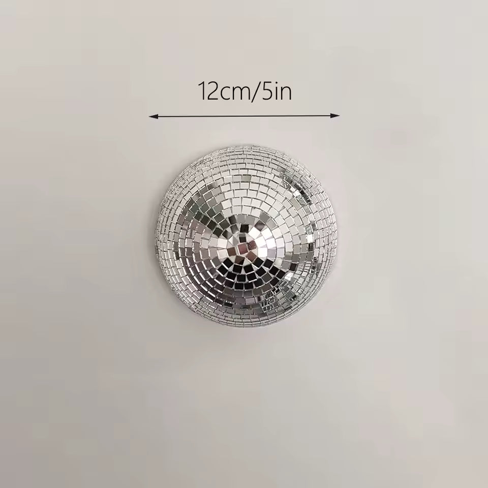 Silver disco ball with dimensions labeled on a light gray background
