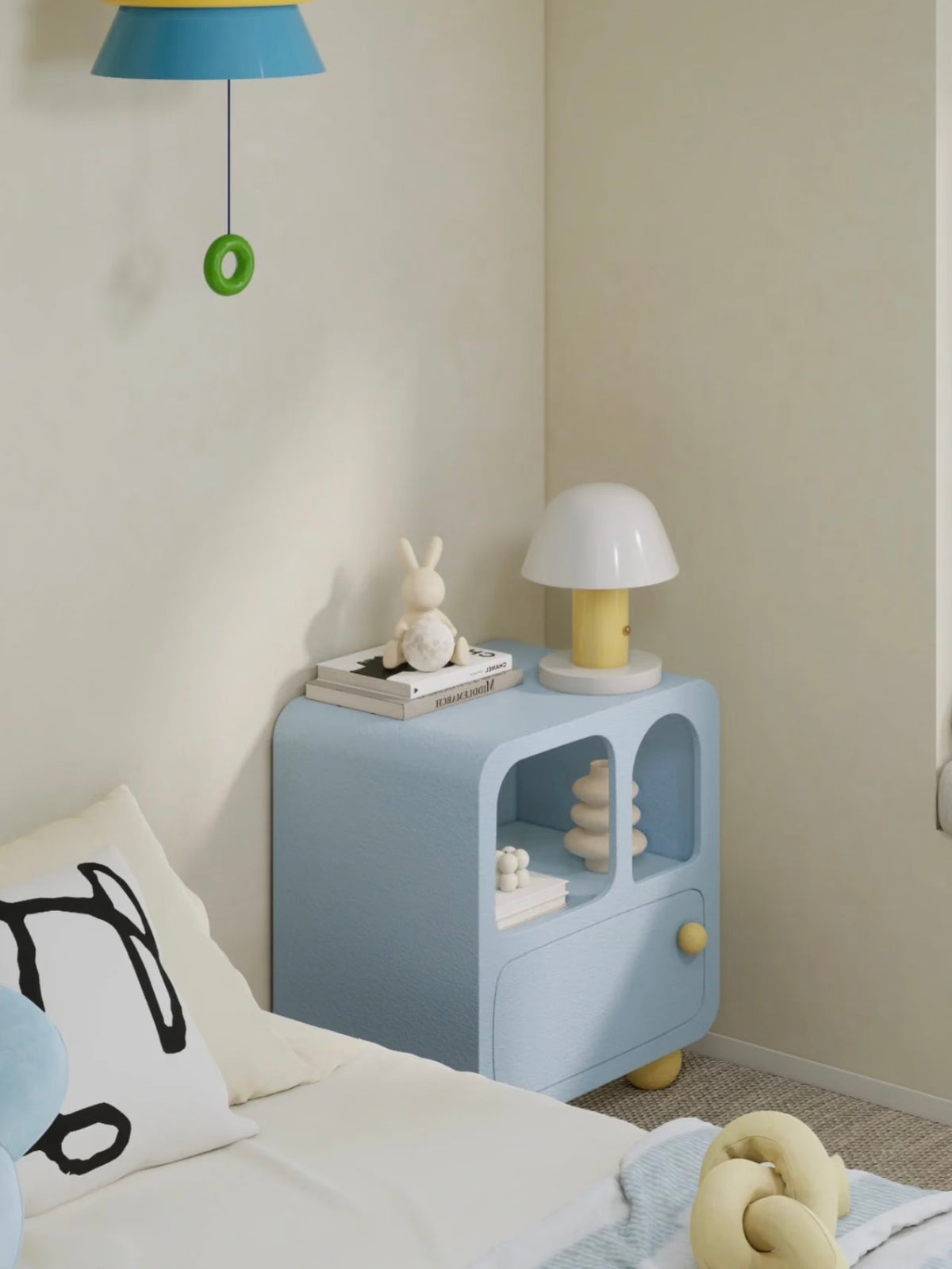 A blue arched nightstand stands beside a bed in a wider view, with books and a dome lamp on top.