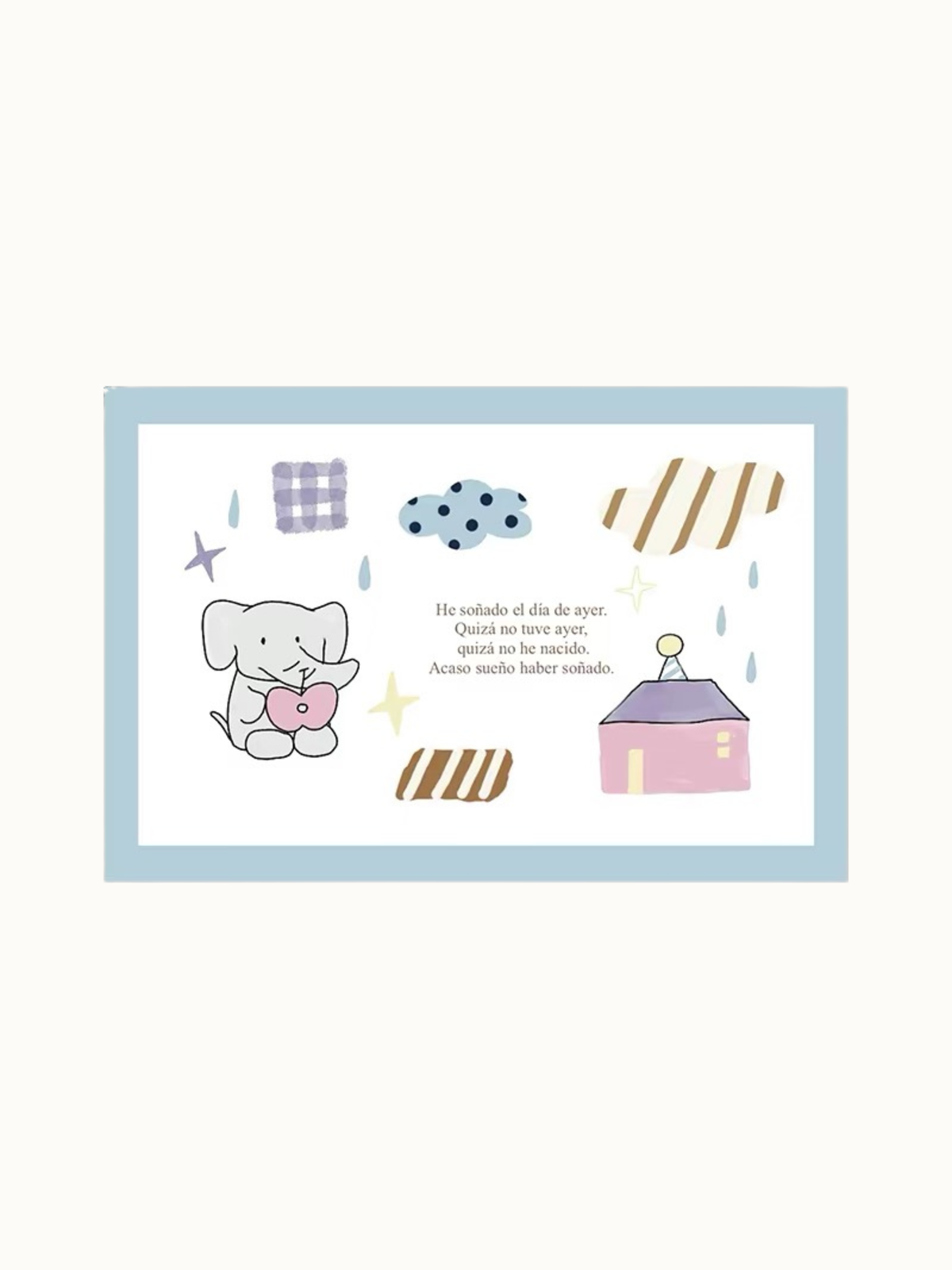 A blue elephant rug design shows an elephant holding a pink heart, a small house, stars and Spanish lettering.