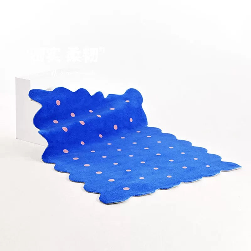 Blue irregular area rug with polka dots styled in modern living room interior space