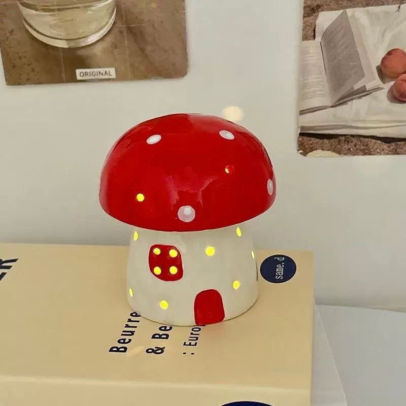 Battery-powered ceramic mushroom lamp next to a book