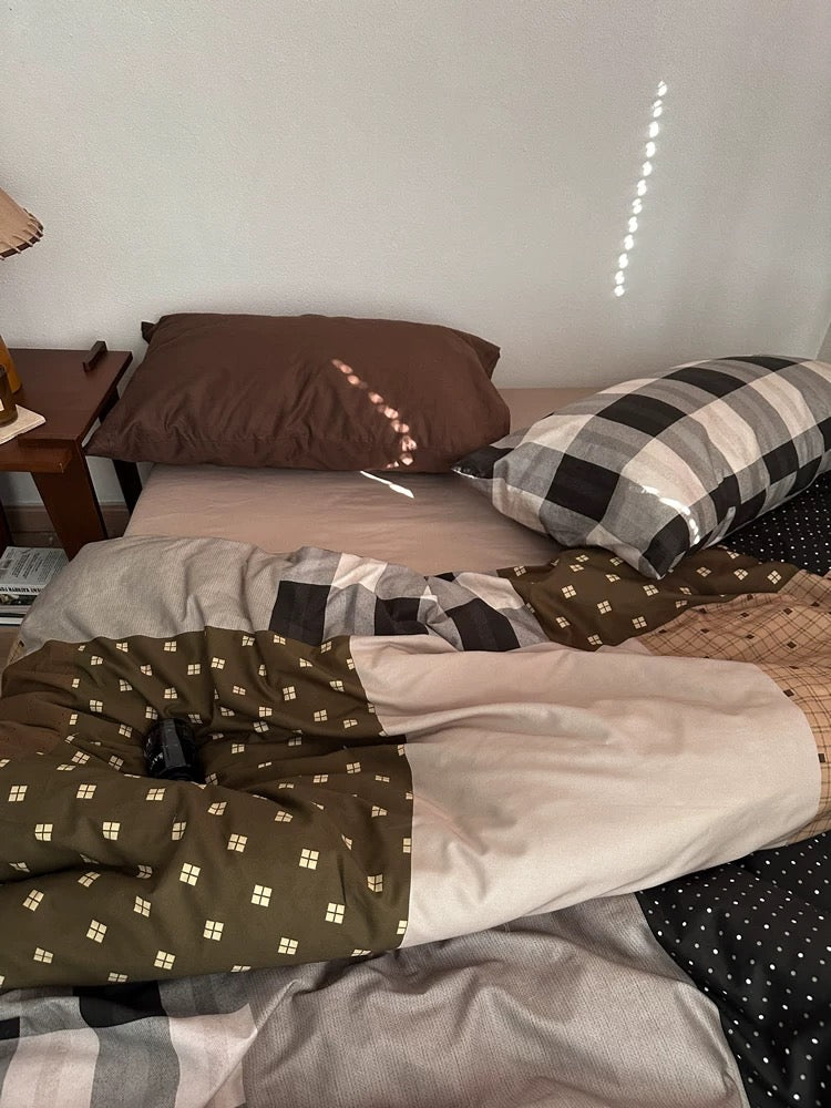 Brown cotton duvet cover with small geometric motifs and contrasting plaid fabric