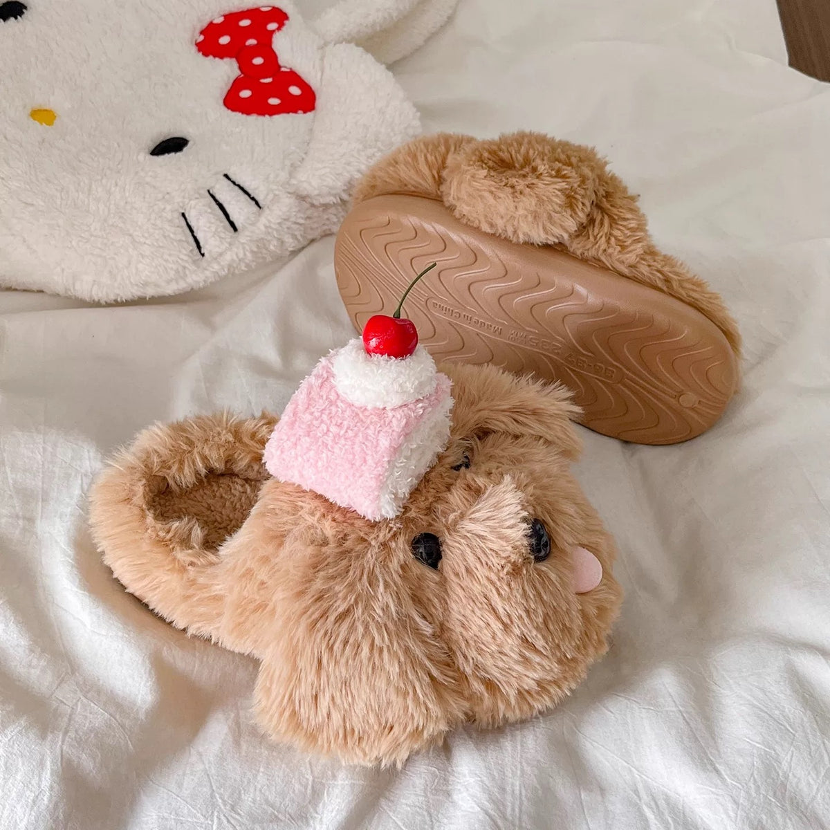 Brown plush puppy slippers with cake and cherry accessories