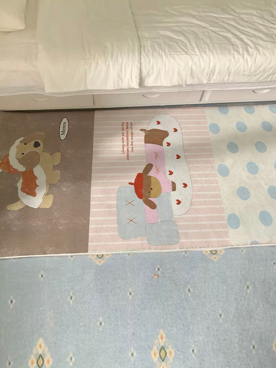 A brown runner rug with cartoon dog artwork, pale stripes and blue dots lies along the side of a bed.