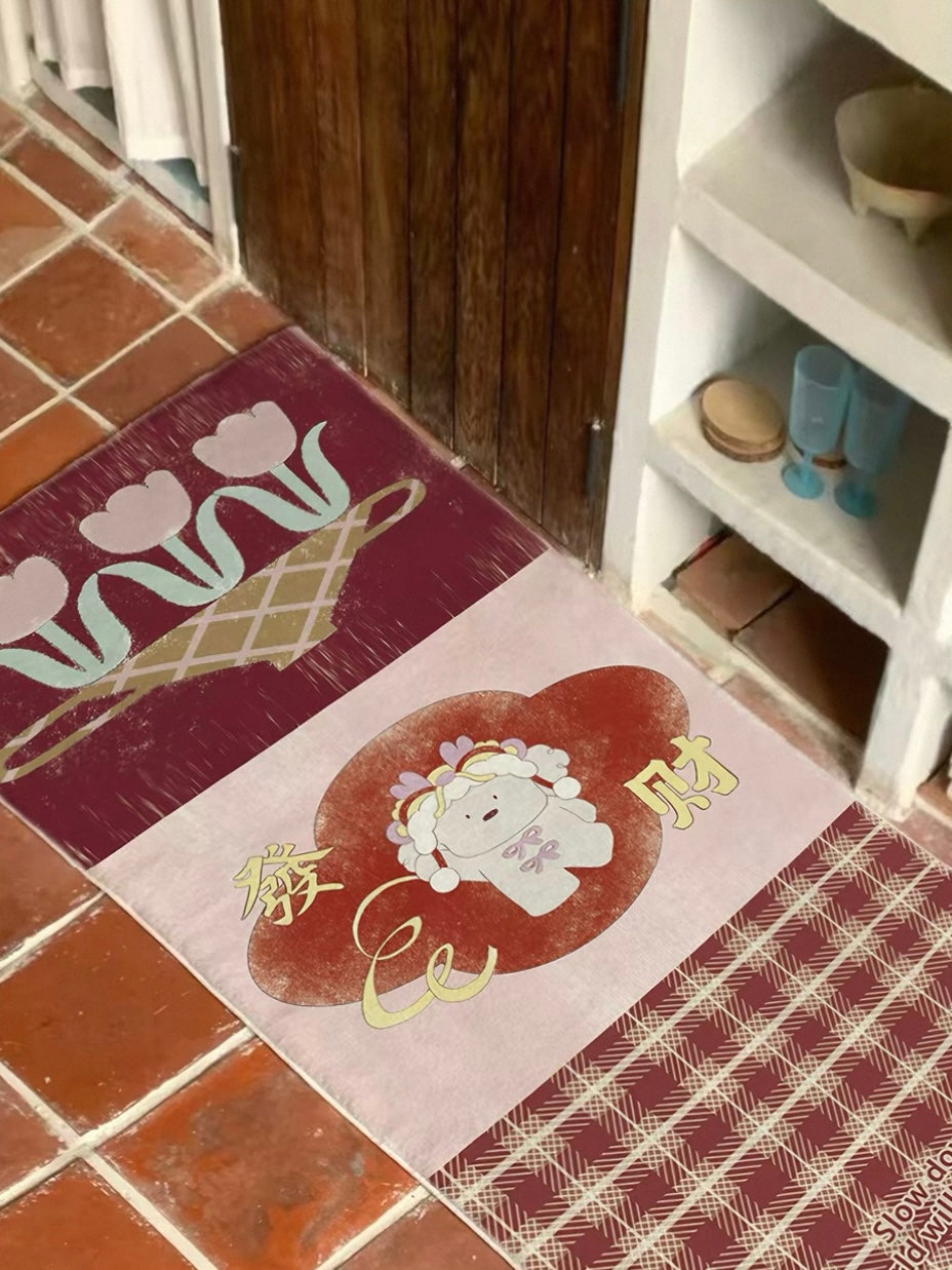 A burgundy runner rug shows pale tulips, a white character and checked artwork beside open shelving.