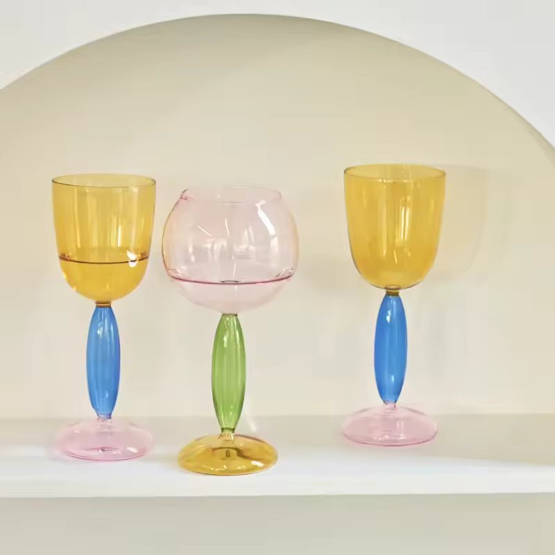 Three colorful glass goblets on a white background