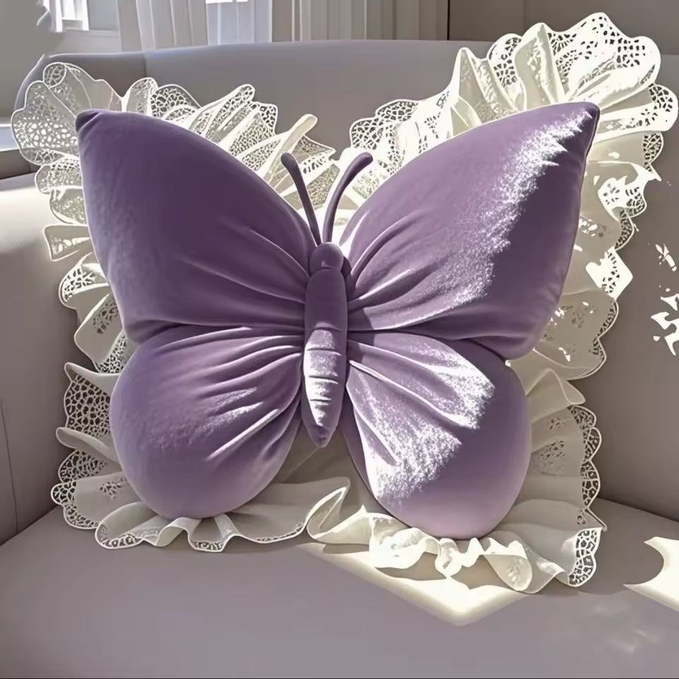 Purple butterfly-shaped pillow on a decorative white surface with lace details