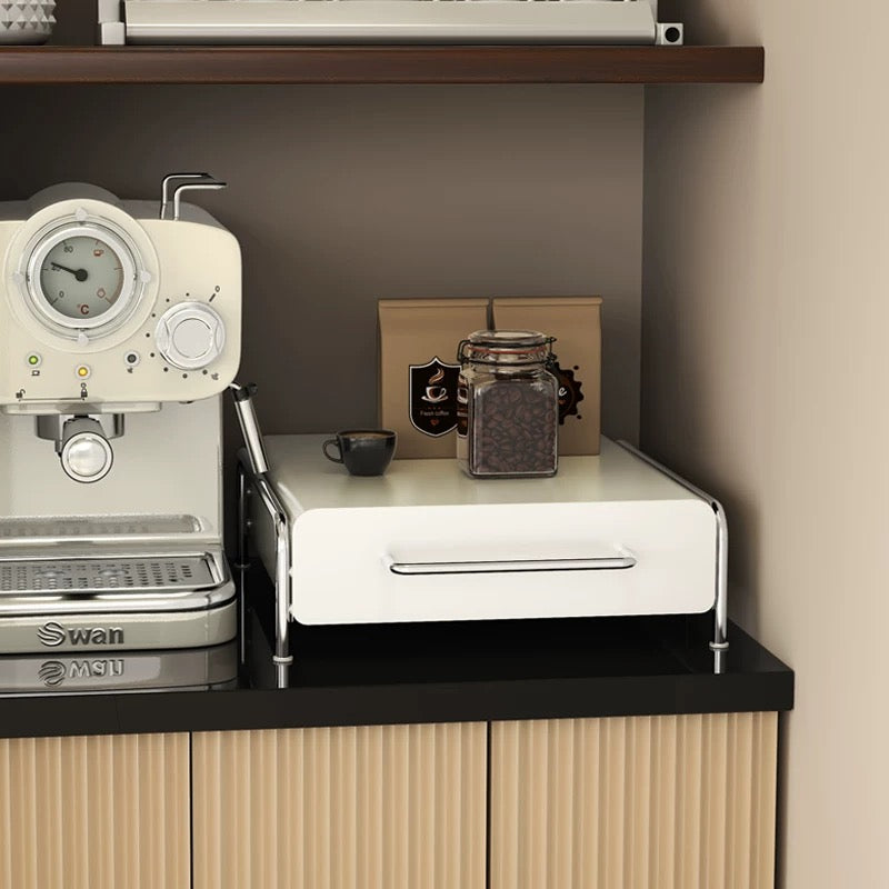 Metal coffee capsule storage drawer showing multiple pod flavors arranged neatly for easy, quick morning coffee choices at home.