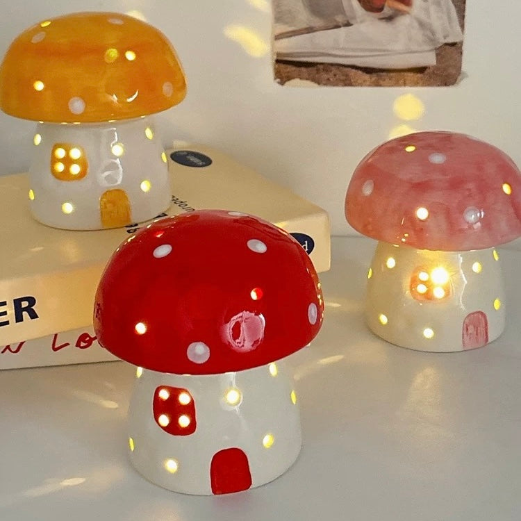 Ceramic mushroom night light in pastel pink on a white table