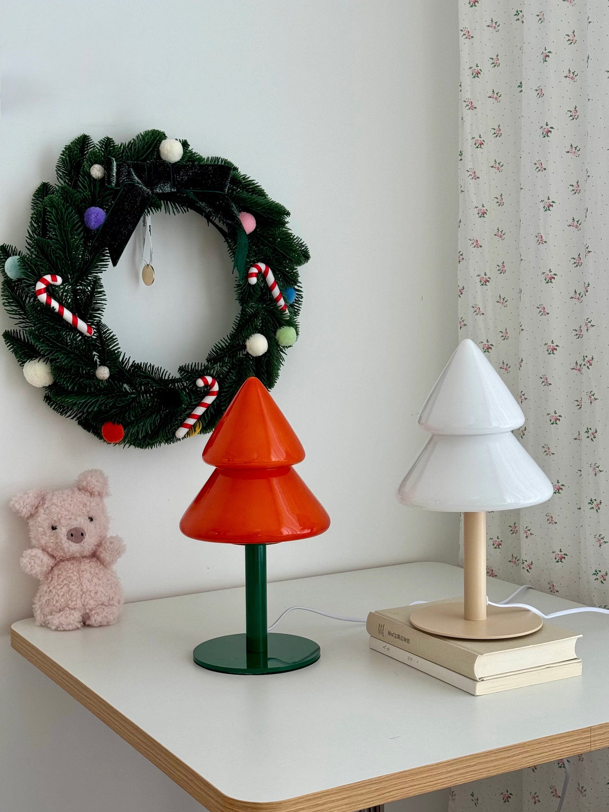 Orange and blue Christmas tree bedside lamps styled with holiday decor
