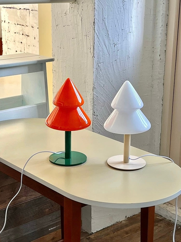 Christmas tree night lamps in orange and blue on a small table