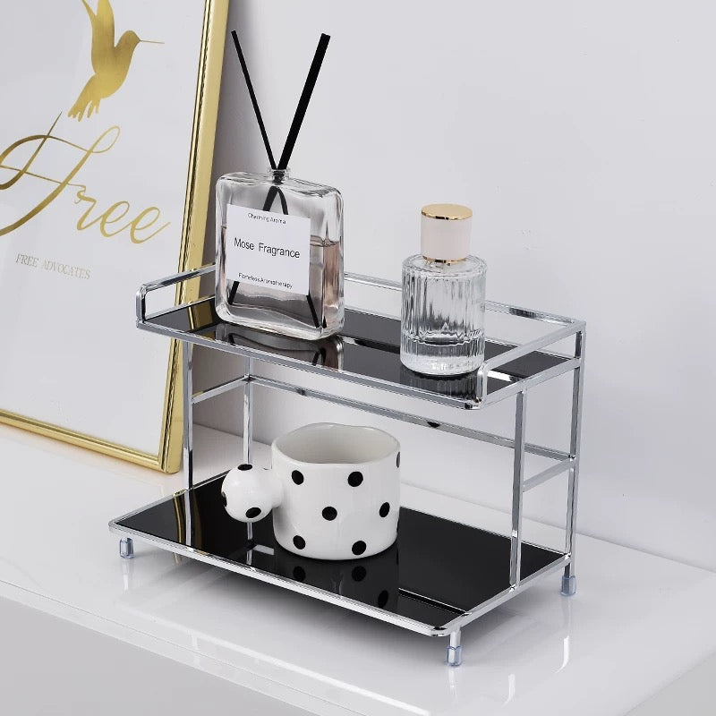 Small metal shelf with decorative items on a white surface