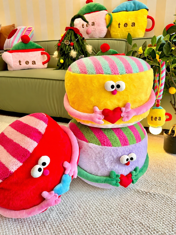 Colorful striped ottoman poufs in red, purple, and yellow with heart details