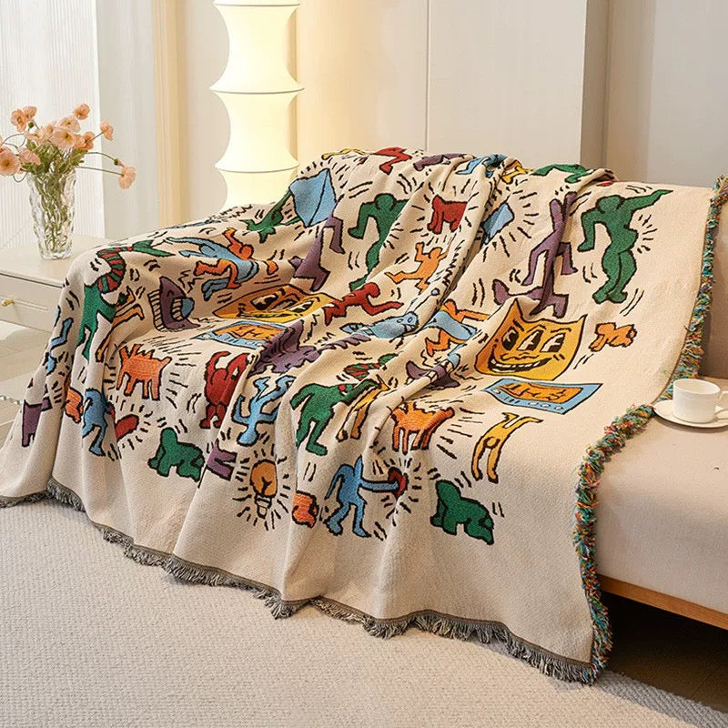 Artistic cotton throw blanket used as a picnic mat on the grass