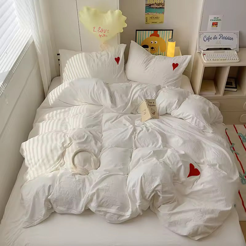 Close-up of soft cotton pillowcases featuring delicate heart patterns.
