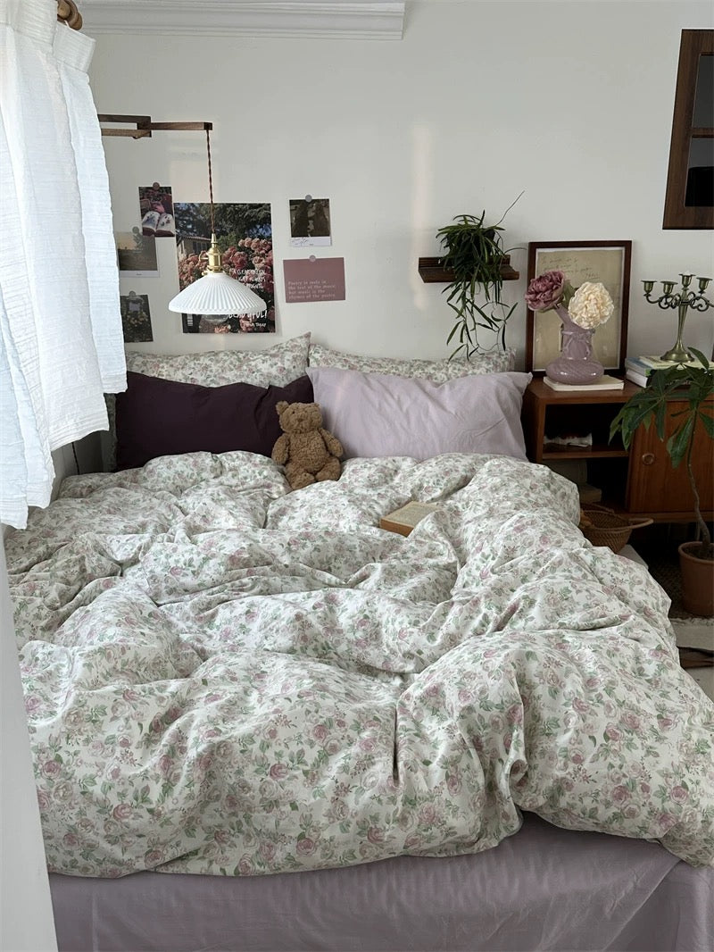 Romantic floral bedding set styled with botanical accents and layered pillows creating warm inviting bedroom retreat naturally.