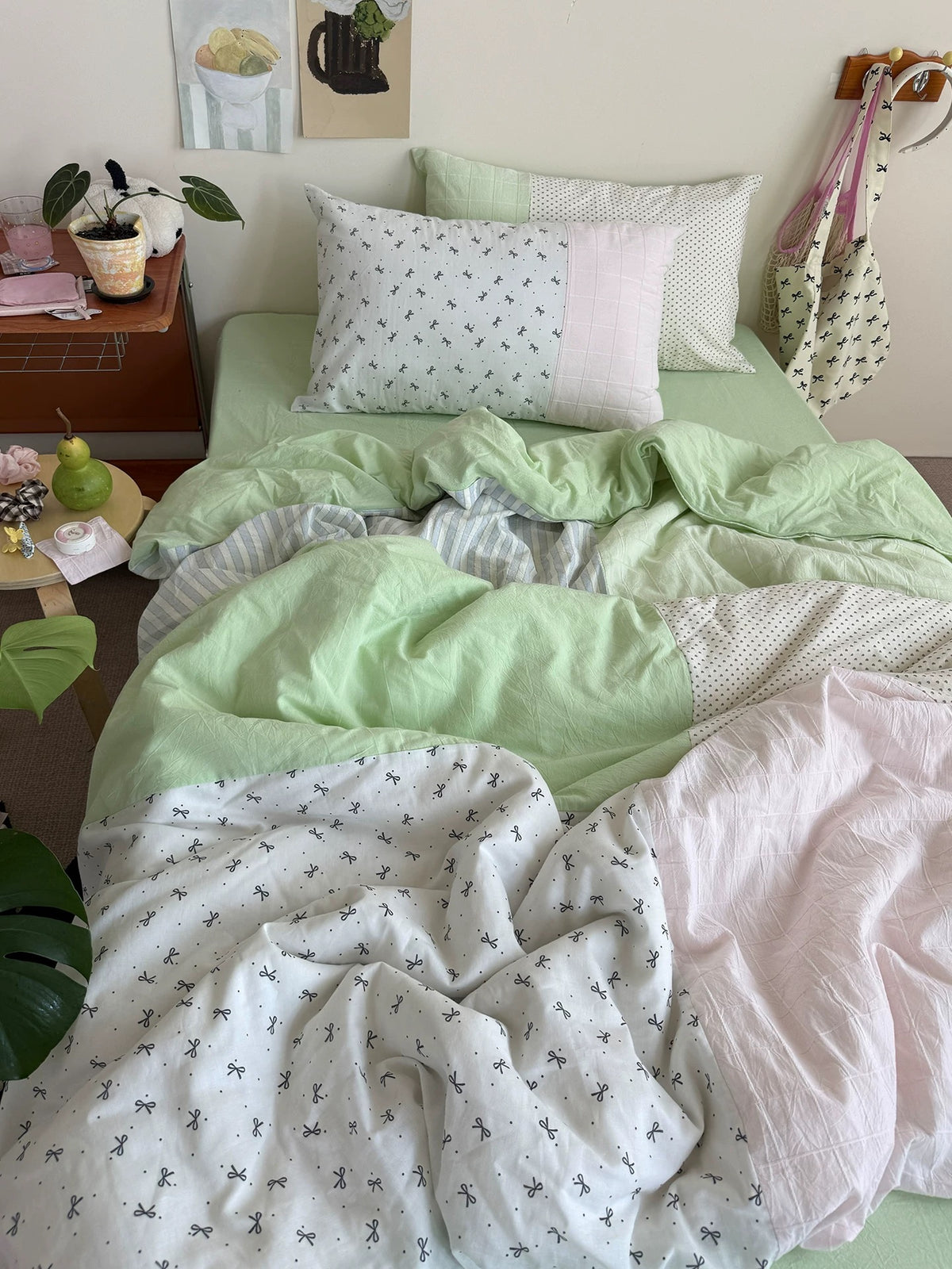 Mint green cotton bedding with pink panels and white bow-print fabric