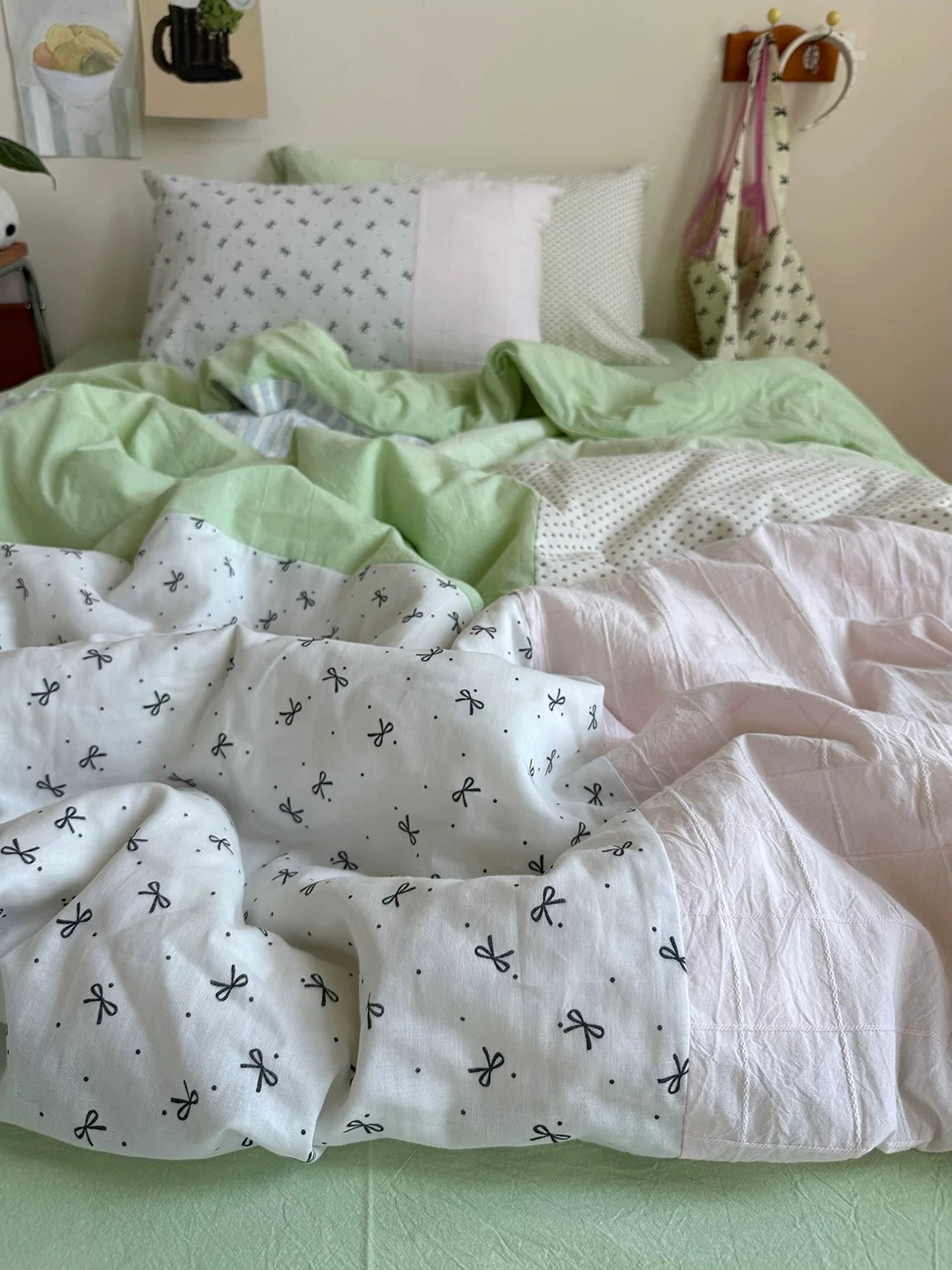Hand-pieced green and pink bedding with small bow-print cotton panels