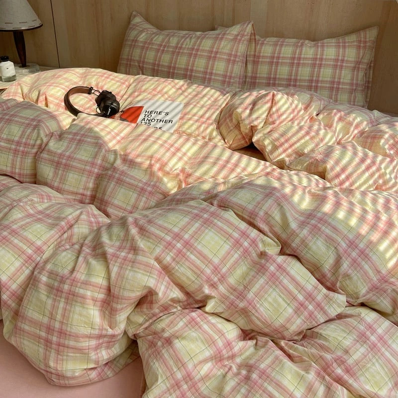 Bed with pink and white checkered bedding and pillows.