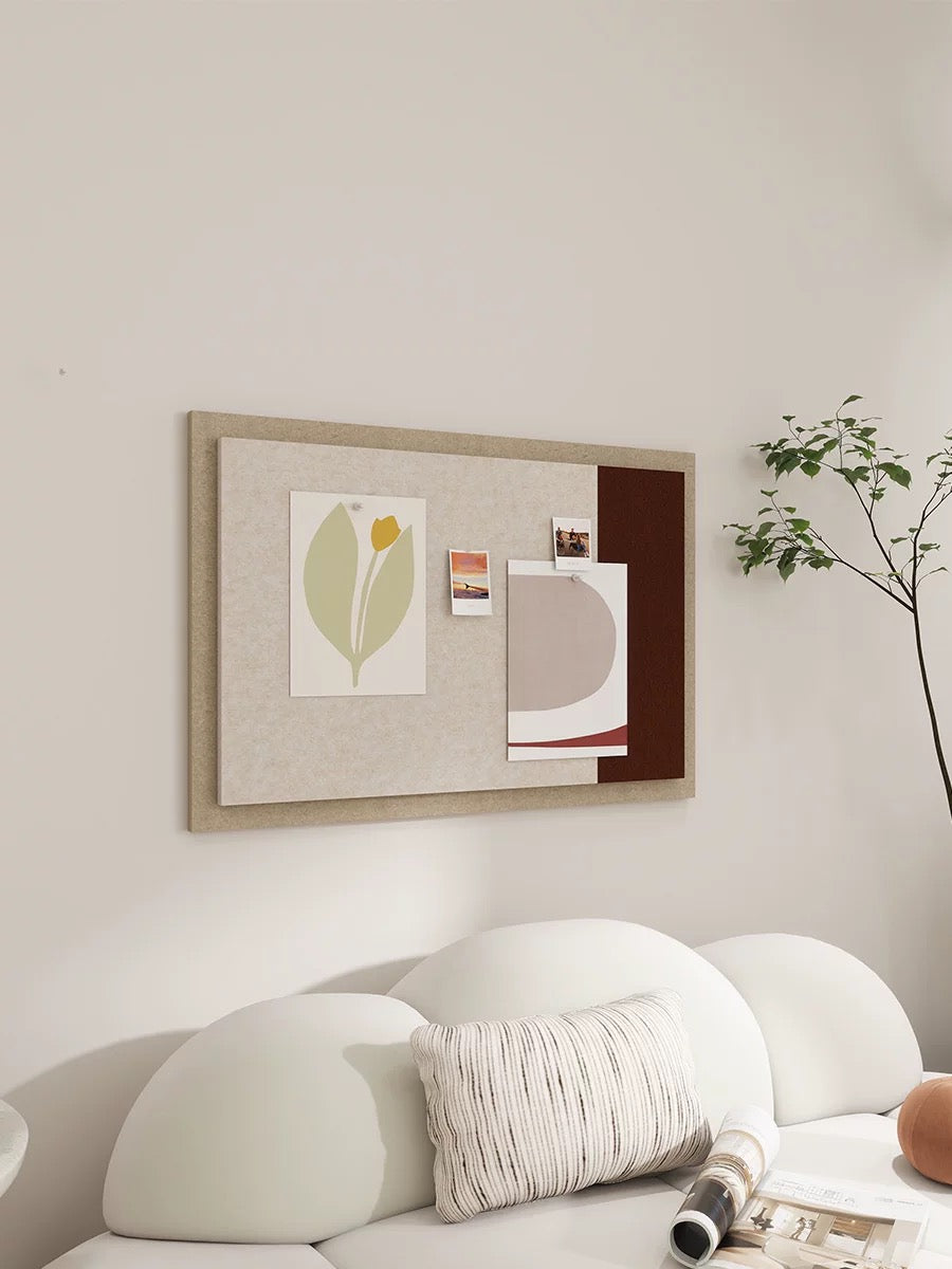 Cream and camel photo display board styled above a neutral bed