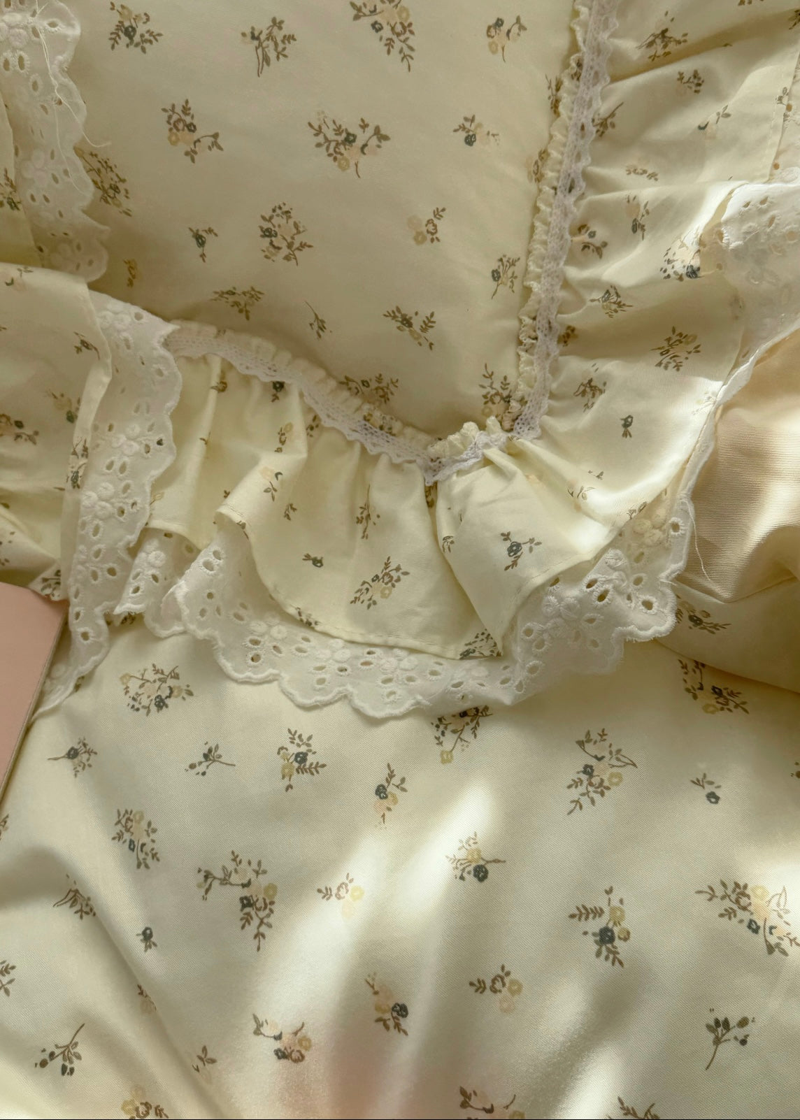 Floral patterned fabric with lace trim on a light background