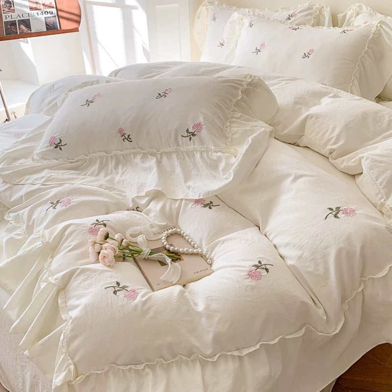 Coquette rose bedding set with embroidered pink roses on a creamy white base