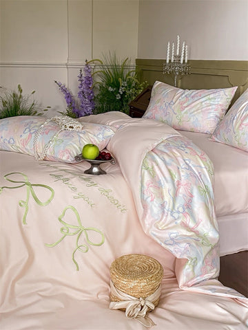 Delicate floral bedding set on a bed with decorative elements.
