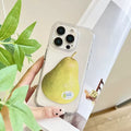 Phone case with a pear design held by a hand, with a plant in the background