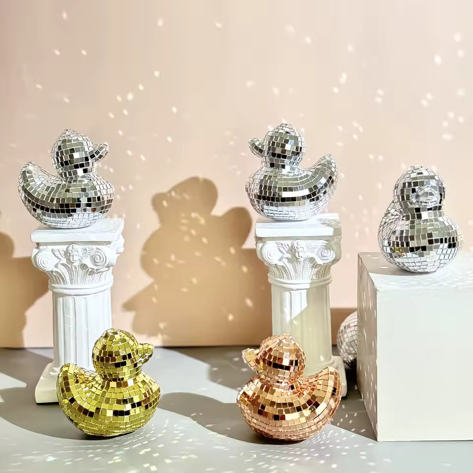 Decorative disco duck figurines on columns against a beige background