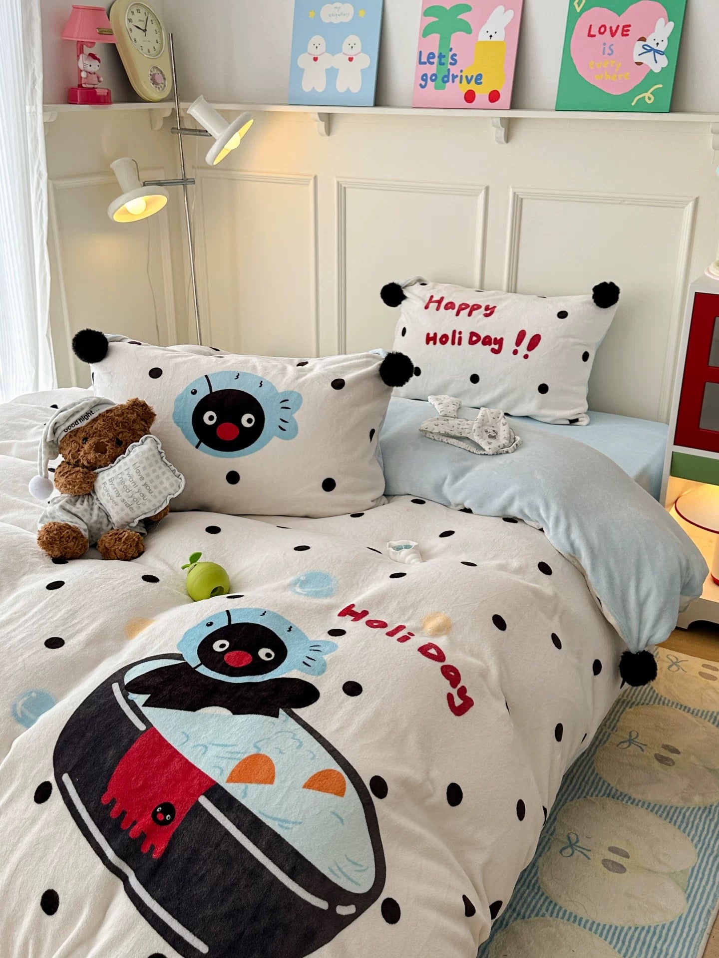 Cute penguin milk fleece bedding set photographed in warm aesthetic dorm room setup