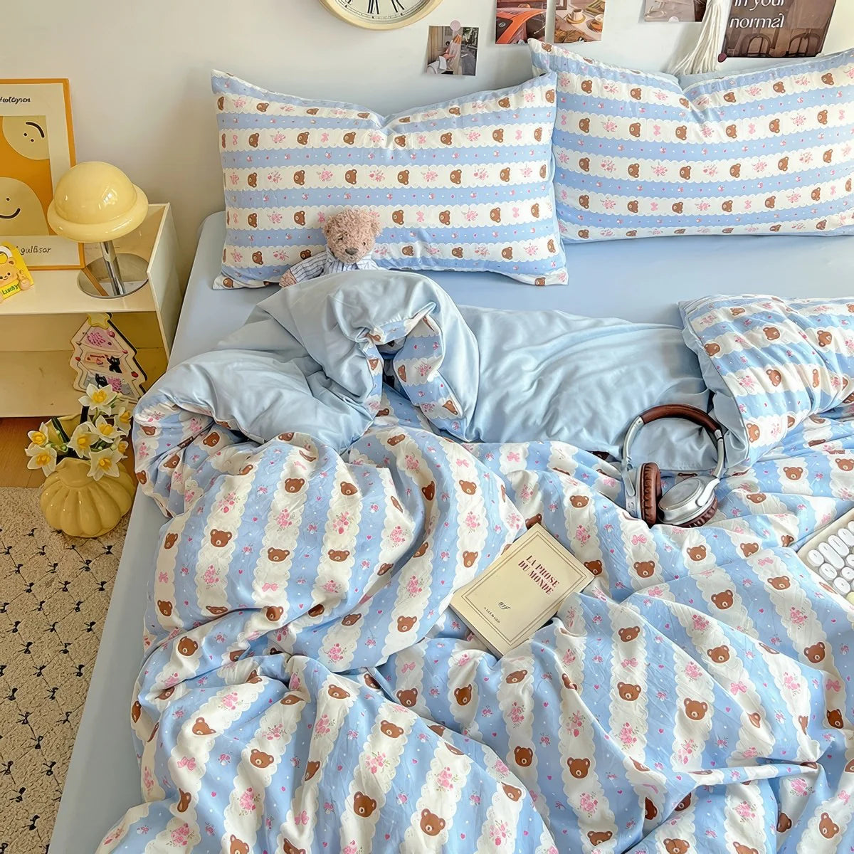 Kawaii pastel blue bedding set styled with plush bear prints for a cozy dorm room look.
