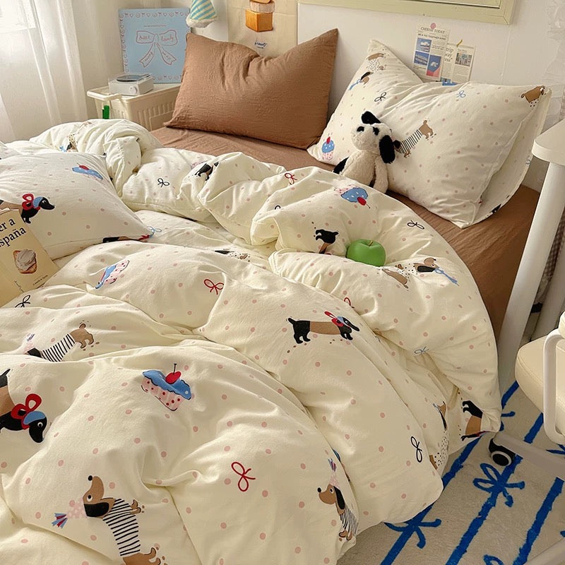 Bed with cartoon-themed bedding and pillows in a bedroom setting.