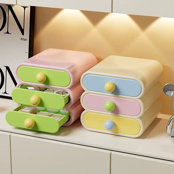 Pastel-colored storage drawers with yellow knobs on a shelf.