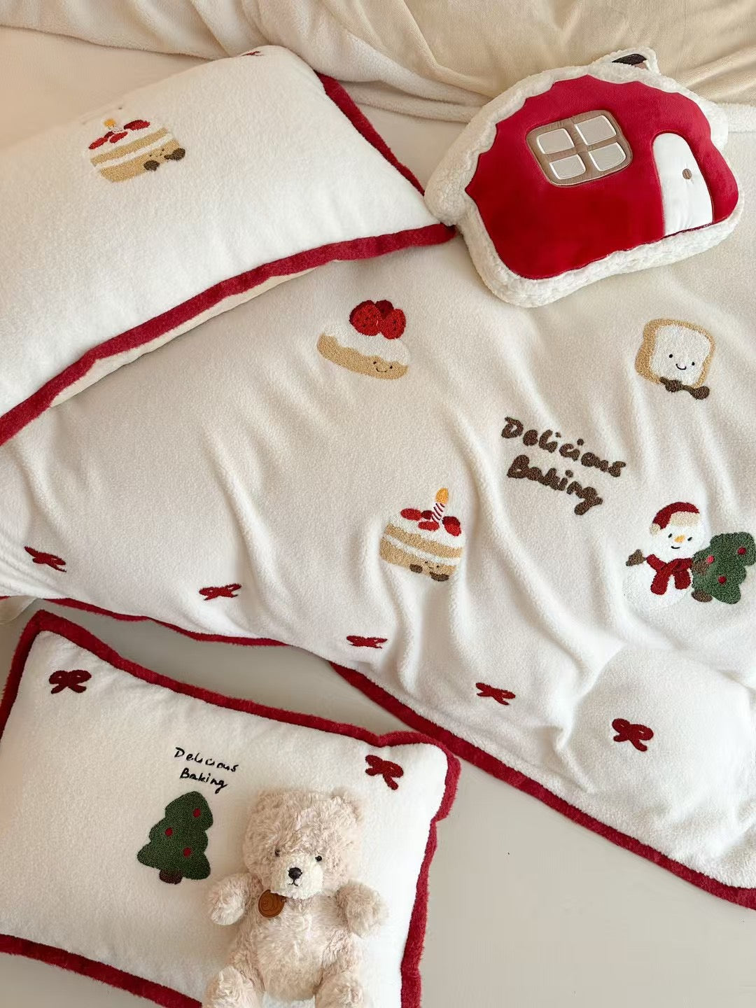 Close-up of white Christmas duvet cover with red trim and embroidered holiday motifs