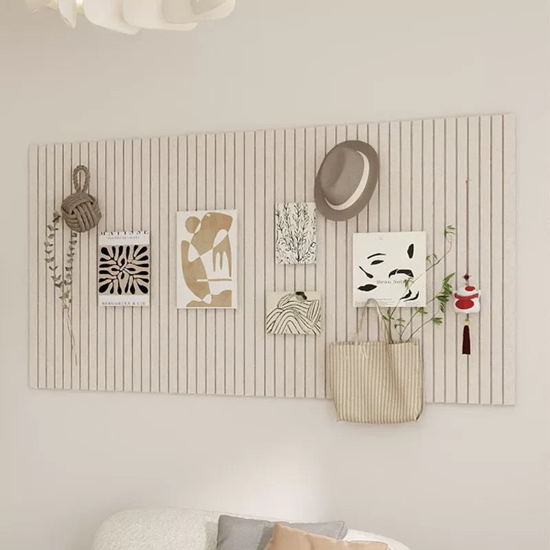 Decorative wall panel with pinned photos and notes on a light gray background