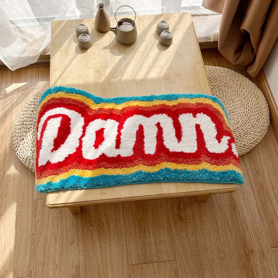 Colorful rainbow rug adding charm to a girly bedroom decor.