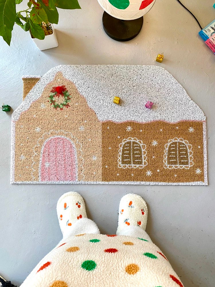 Cream gingerbread house doormat viewed from above in a festive room