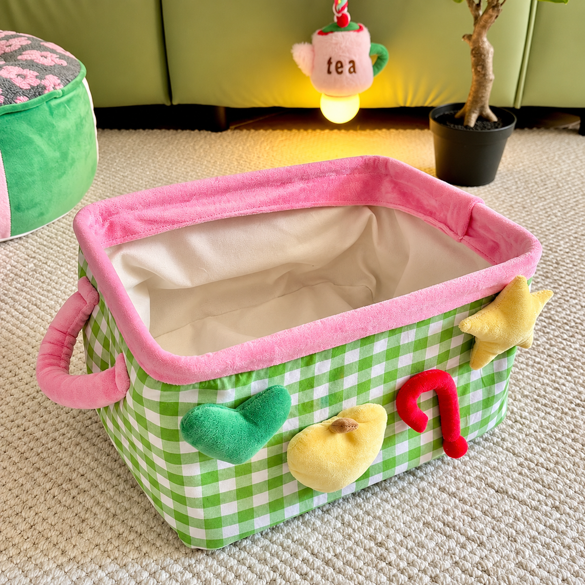 Green checkered storage basket with handles and colorful front details