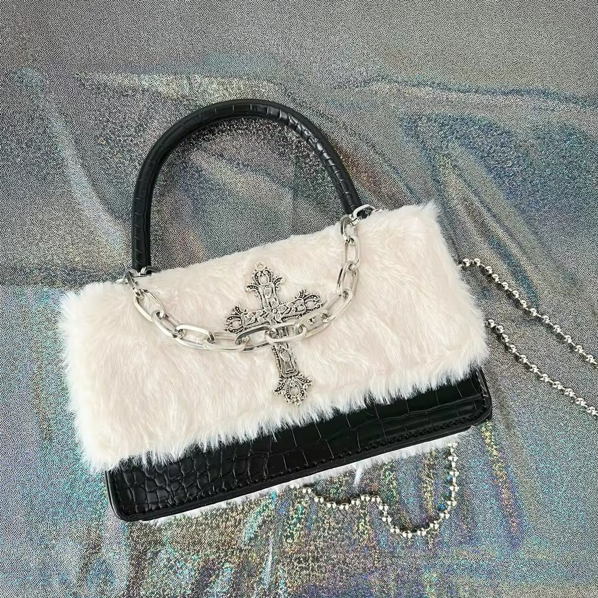 Black square gothic handbag with plush leather finish. Y2K grunge crossbody bag for subculture-inspired fashion looks.