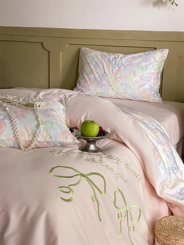 Delicate floral bedding set on a bed with decorative elements.