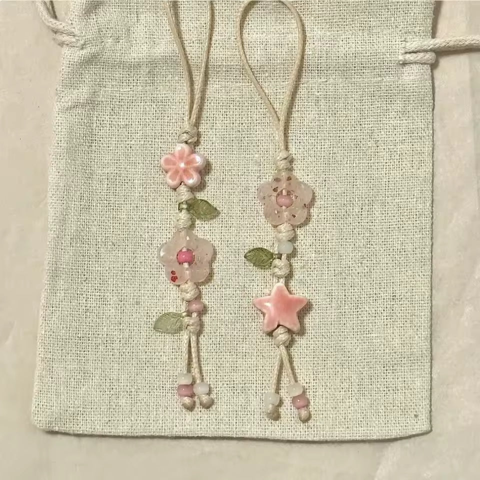 Decorative bookmarks with floral and star designs on a textured fabric background