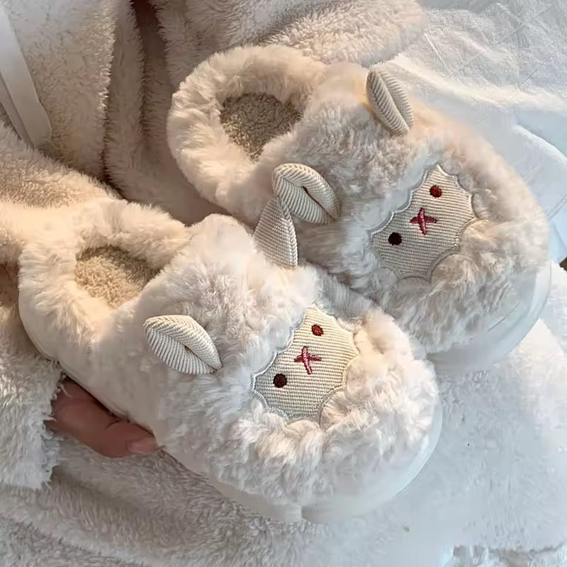 Pink fluffy slippers with bunny design on a soft white background