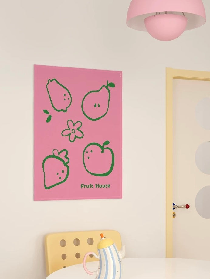 A pink Kawaii tapestry with fruit outlines hangs vertically above a yellow chair beside a pale door.