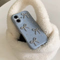 Phone case with decorative bows on a fluffy white surface