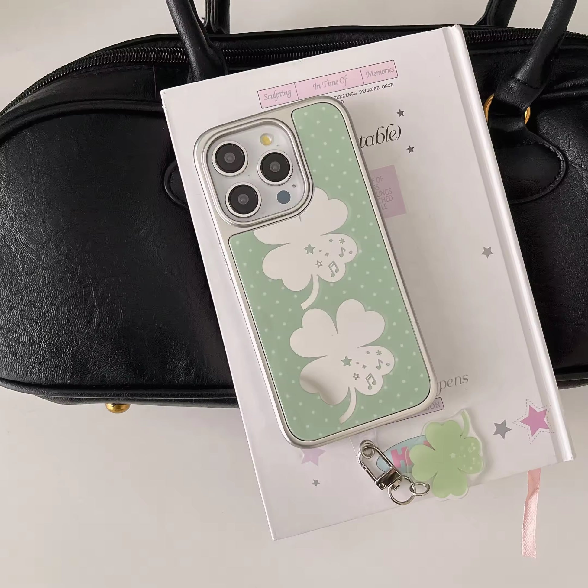 Soft girl aesthetic four-leaf clover iPhone case photographed on white background